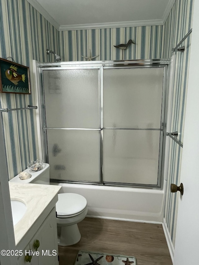 bathroom featuring bath / shower combo with glass door, crown molding, vanity, and wallpapered walls