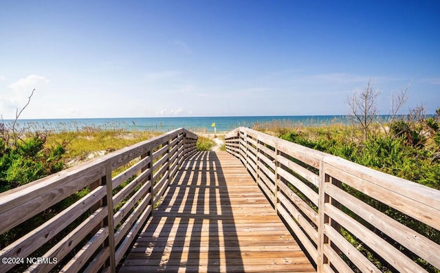 view of community with a beach view and a water view