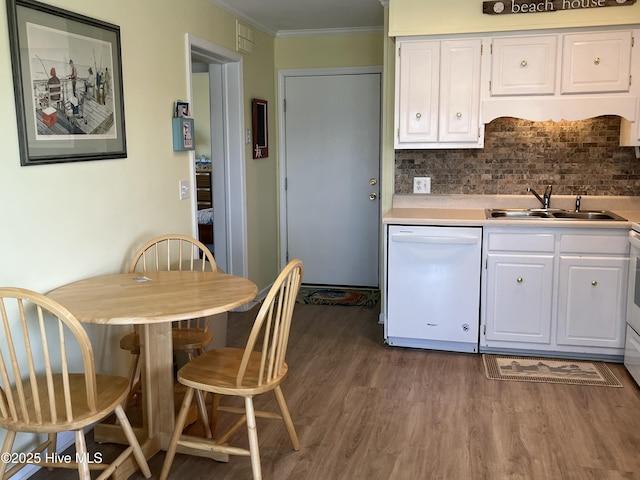 kitchen with white dishwasher, white cabinetry, dark wood-type flooring, and crown molding