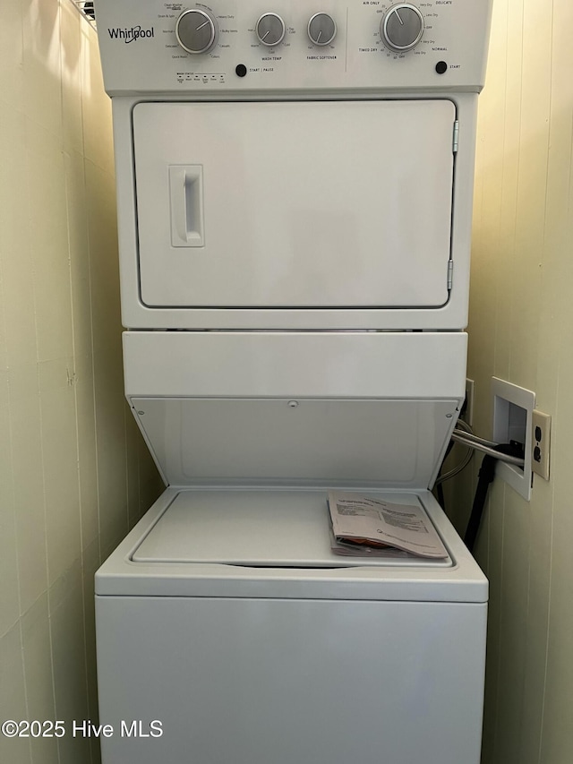 washroom with laundry area and stacked washing maching and dryer