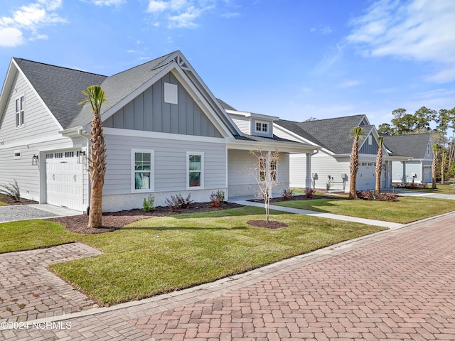 view of front of house featuring a front yard and a garage