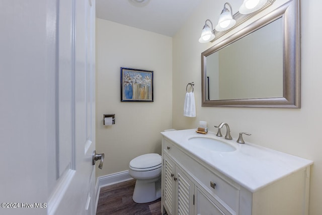 bathroom featuring hardwood / wood-style flooring, vanity, and toilet