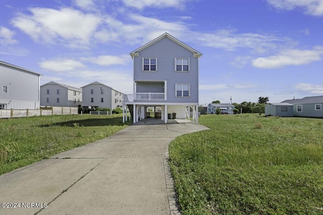 view of front facade featuring a carport and a front lawn