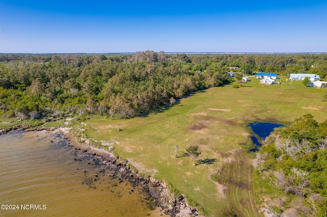 birds eye view of property with a view of trees