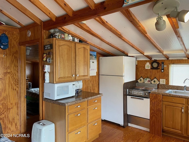 kitchen with lofted ceiling with beams, a sink, wooden walls, wood finished floors, and white appliances