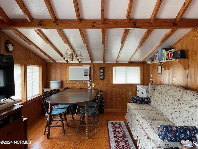 dining space with light wood-style flooring, wood walls, lofted ceiling with beams, and a wall mounted AC