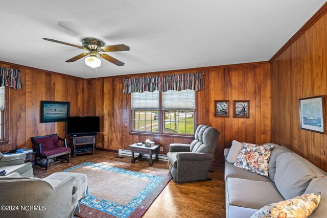 home office featuring ceiling fan, a textured ceiling, light colored carpet, ornamental molding, and a baseboard radiator