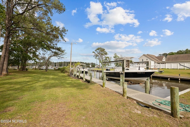 view of dock featuring a water view and a lawn