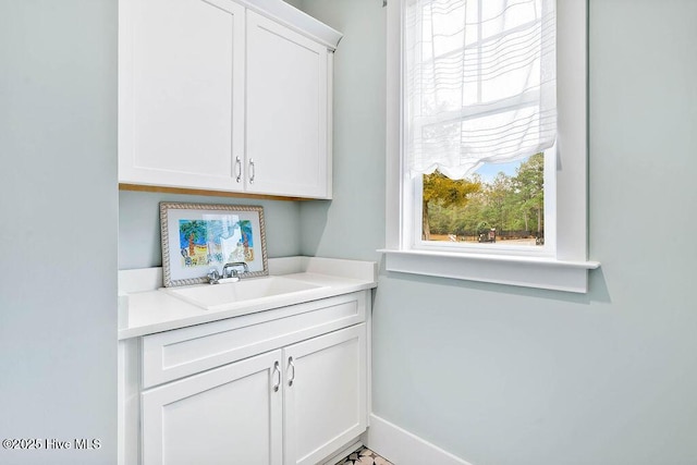 clothes washing area with sink