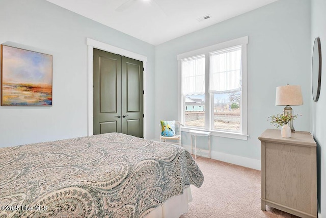 carpeted bedroom with a closet