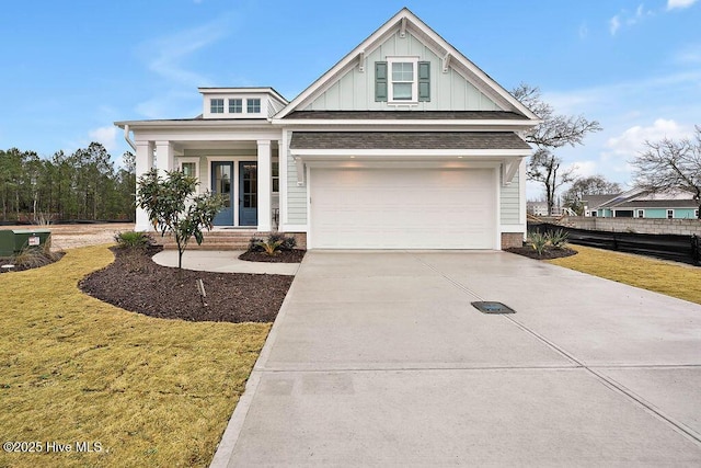 view of front of property featuring a garage, a front lawn, and central air condition unit