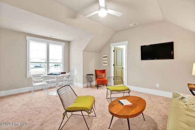 sitting room featuring vaulted ceiling, light colored carpet, and ceiling fan