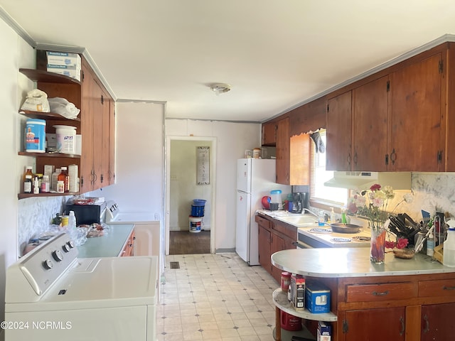 kitchen featuring sink, independent washer and dryer, and white fridge