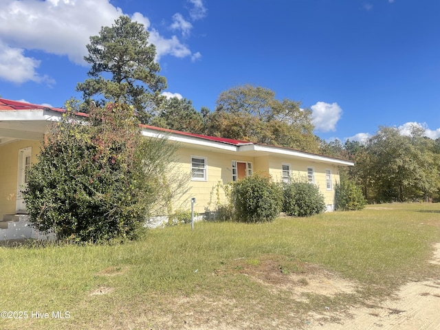 view of property exterior with a lawn