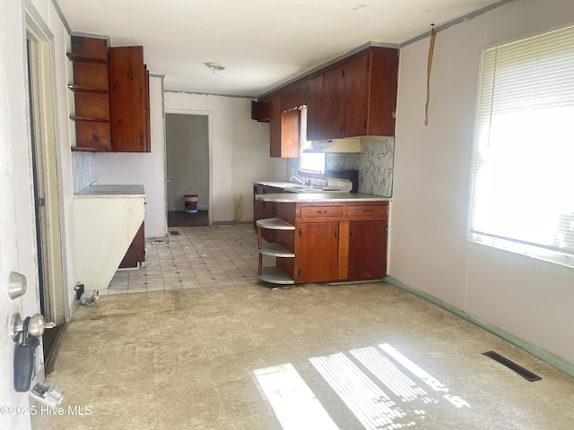 kitchen with tasteful backsplash and plenty of natural light