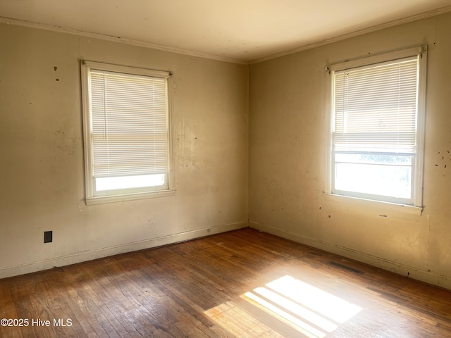 unfurnished room with crown molding and hardwood / wood-style flooring