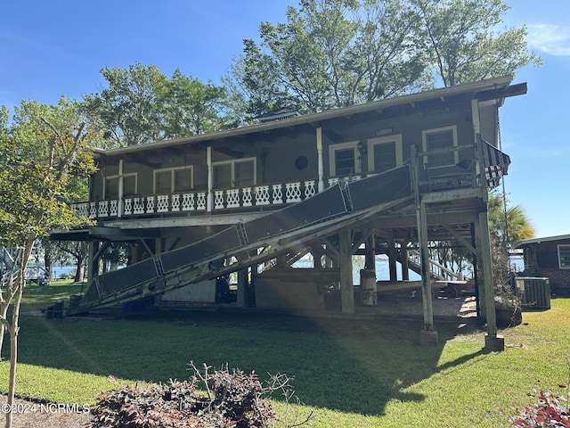 back of property featuring a deck, central AC unit, and a lawn