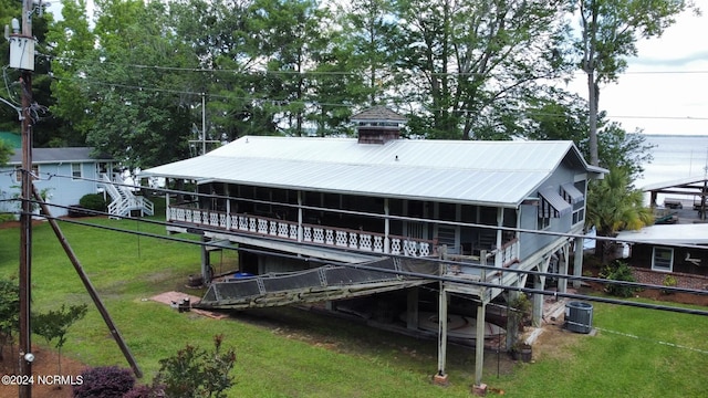 back of property featuring a yard and central air condition unit