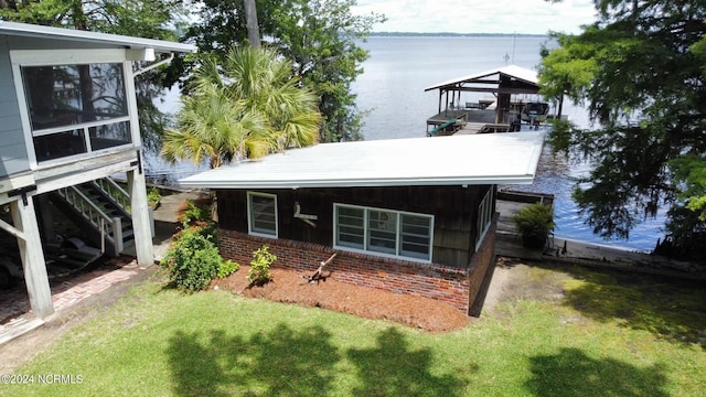 exterior space with a lawn and a water view