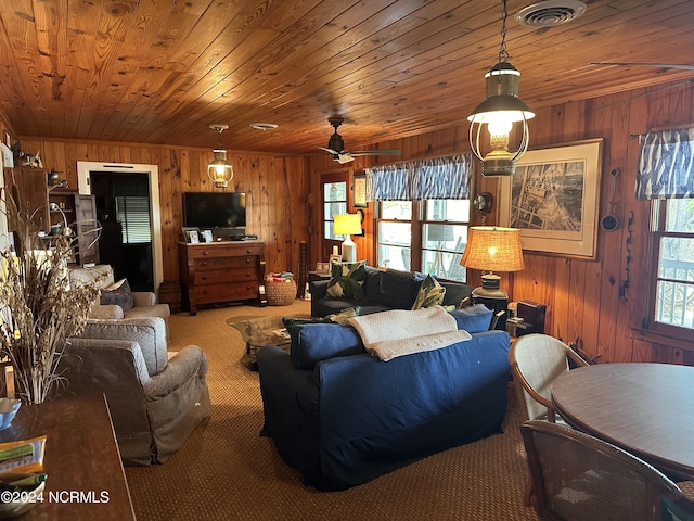 living room with wood walls, carpet, ceiling fan, and wood ceiling