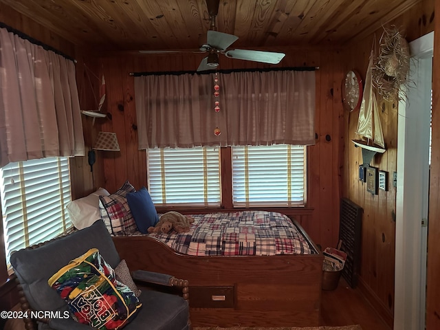 bedroom featuring wooden walls and wood ceiling