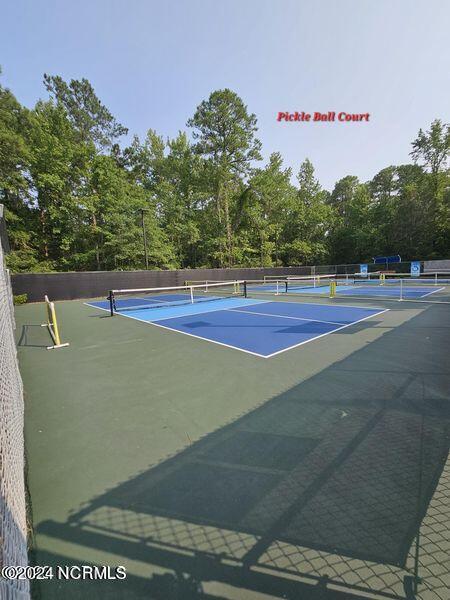 view of tennis court with fence