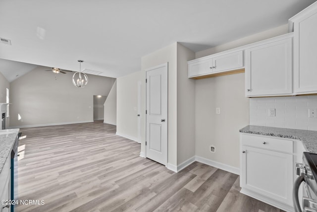 200 Slater Way, Jacksonville, NC 28540 - kitchen featuring stove, light wood-type flooring, open floor plan, a chandelier, and white cabinetry