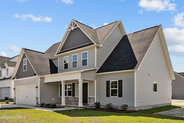 craftsman-style house with covered porch, a front yard, and a garage