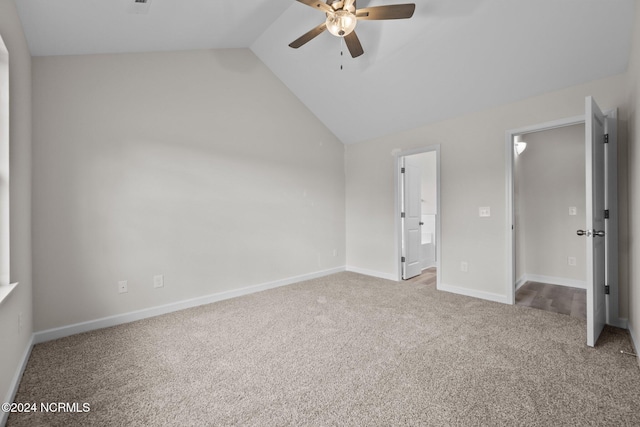 unfurnished bedroom with lofted ceiling, carpet flooring, ensuite bath, and ceiling fan