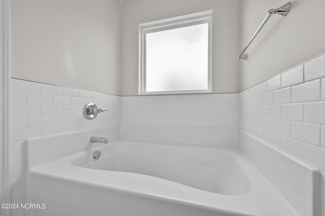 bathroom with a tub to relax in