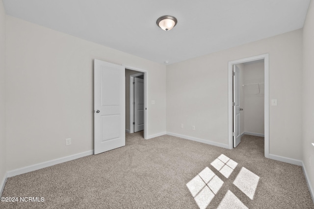 200 Slater Way, Jacksonville, NC 28540 - unfurnished bedroom with carpet floors, a walk in closet, baseboards, and a closet