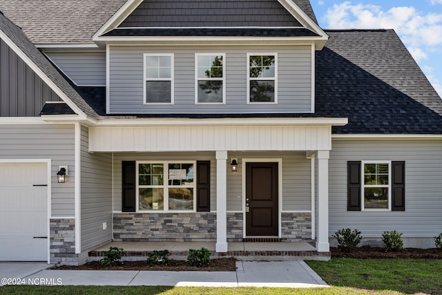 view of front of property with a porch and a garage