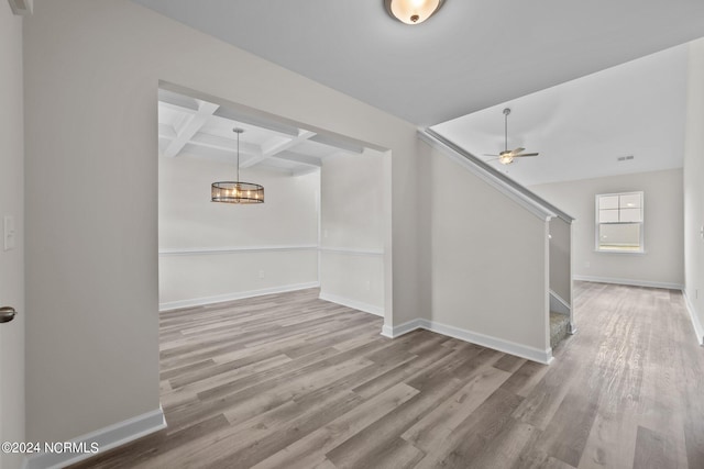 interior space with coffered ceiling, beamed ceiling, hardwood / wood-style flooring, and ceiling fan