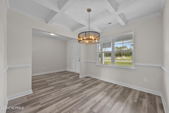 empty room with wood-type flooring, coffered ceiling, crown molding, and beamed ceiling