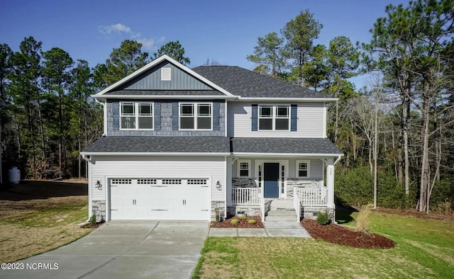 craftsman inspired home with a garage, a front lawn, and covered porch