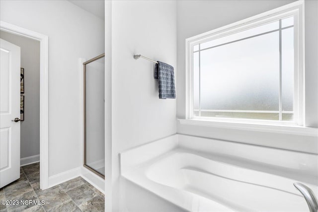 1430 Mona Passage Ct, New Bern, NC 28560 - full bathroom with a stall shower, a garden tub, baseboards, and stone finish flooring