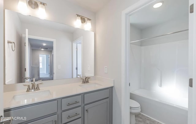 full bathroom featuring shower / bath combination, vanity, and toilet