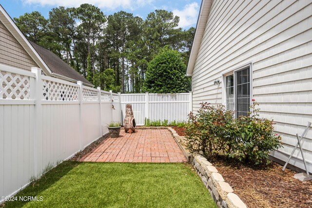 view of yard featuring a patio area and a fenced backyard