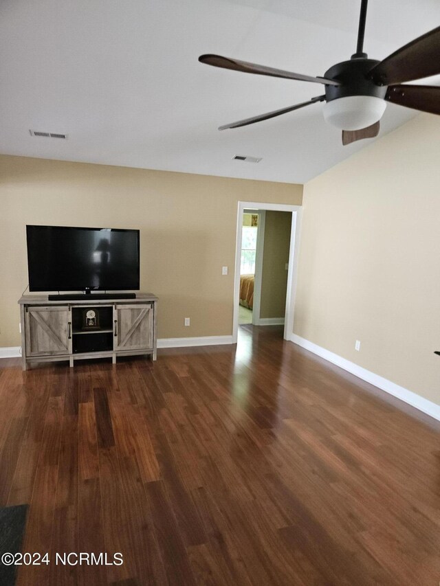 unfurnished living room with dark wood-style floors, baseboards, and visible vents