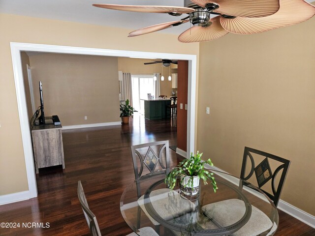 dining area with ceiling fan, baseboards, and wood finished floors