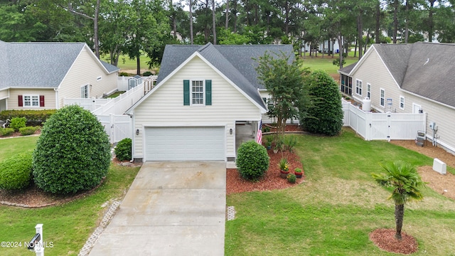 traditional home featuring a gate, fence, concrete driveway, and a front yard