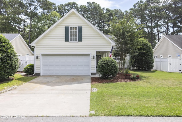 traditional-style house featuring driveway, a gate, fence, and a front yard