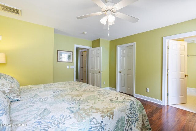 bedroom with visible vents, ceiling fan, baseboards, and wood finished floors