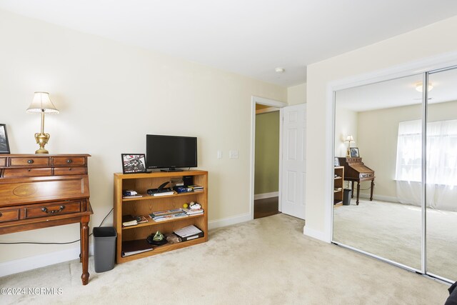 carpeted bedroom with baseboards and a closet