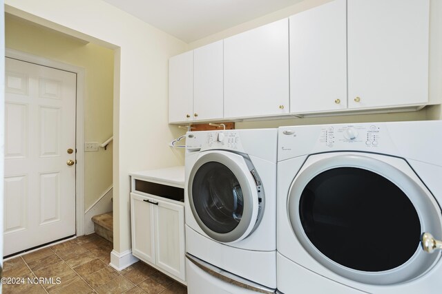 clothes washing area with independent washer and dryer and cabinet space