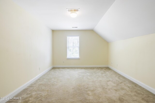 bonus room with vaulted ceiling, carpet flooring, visible vents, and baseboards