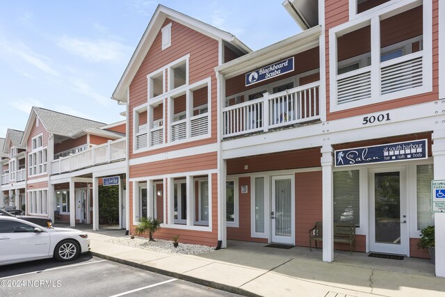 view of property featuring uncovered parking