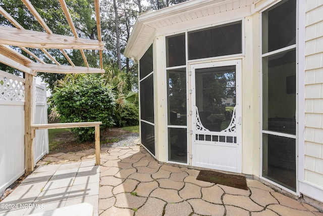 doorway to property with a patio, fence, and a pergola