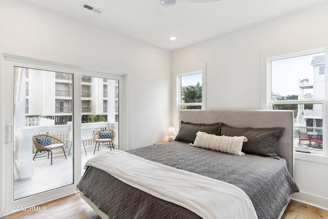 bedroom featuring access to outside and light wood-type flooring