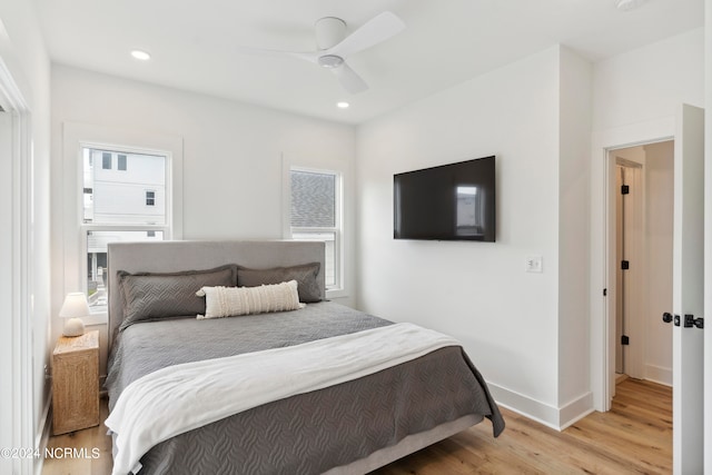 bedroom with light wood-type flooring and ceiling fan